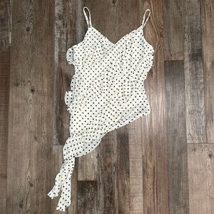 White polka dot asymmetrical going out top with tie detail.